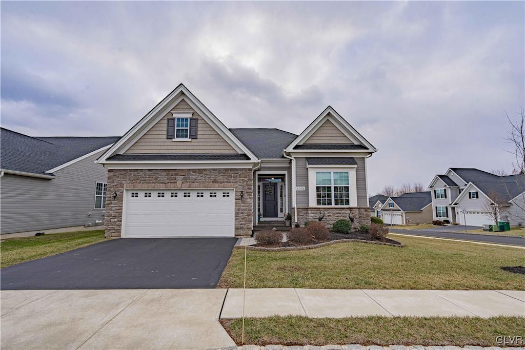 craftsman house with a front lawn and a garage