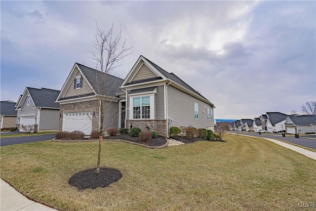 view of front of home with a front yard and a garage