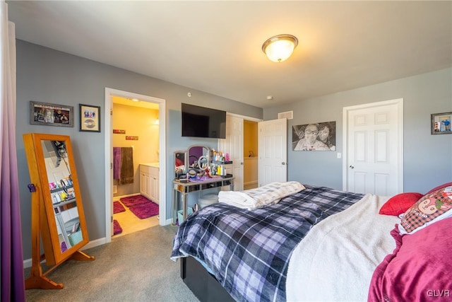 bedroom featuring carpet flooring and connected bathroom