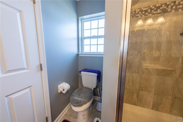 bathroom featuring toilet and walk in shower