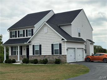 view of front of property with a garage and a front lawn