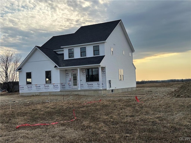 view of front of home featuring covered porch and roof with shingles