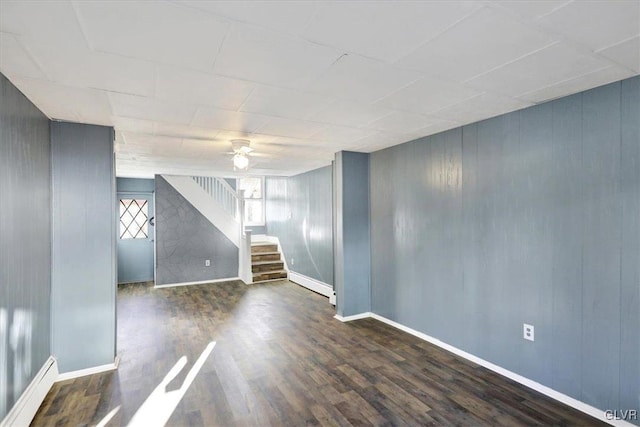 unfurnished room with ceiling fan, dark wood-type flooring, and a baseboard radiator