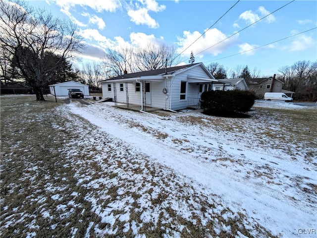 exterior space with an outbuilding, a porch, and a garage