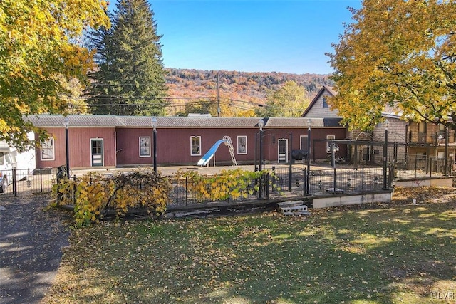 rear view of property with a yard