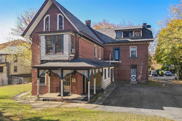 view of front of home featuring a porch and cooling unit