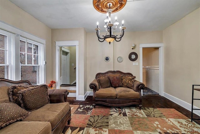 living room featuring dark hardwood / wood-style flooring and an inviting chandelier