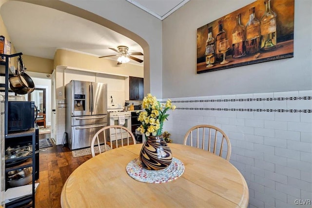 dining space featuring ceiling fan, dark hardwood / wood-style floors, and ornamental molding