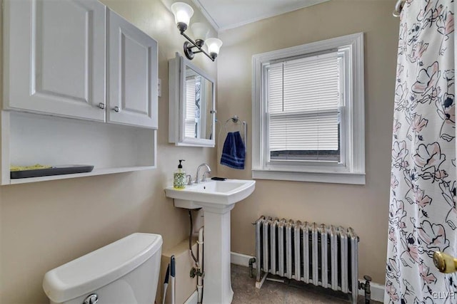 bathroom with a notable chandelier, toilet, sink, and radiator