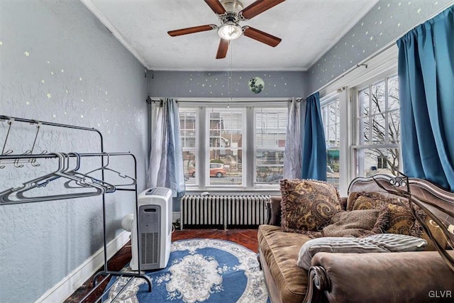 bedroom with hardwood / wood-style flooring, ceiling fan, radiator heating unit, and ornamental molding