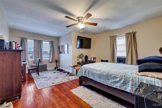 bedroom with radiator, ceiling fan, and dark hardwood / wood-style floors