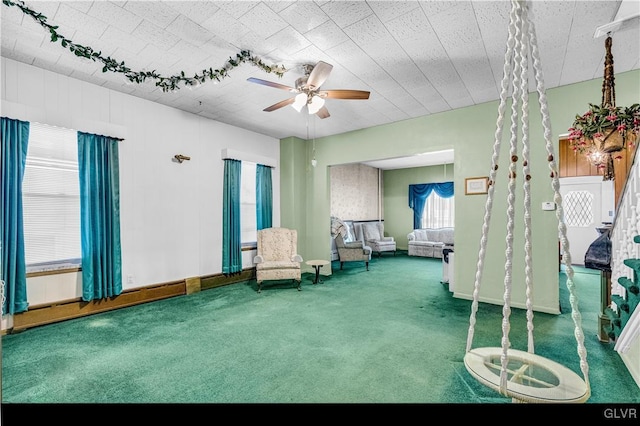 unfurnished room with carpet flooring and ceiling fan