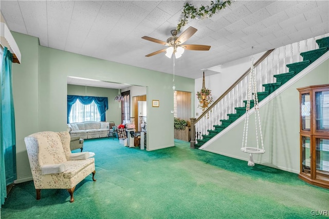 living area with ceiling fan and carpet floors