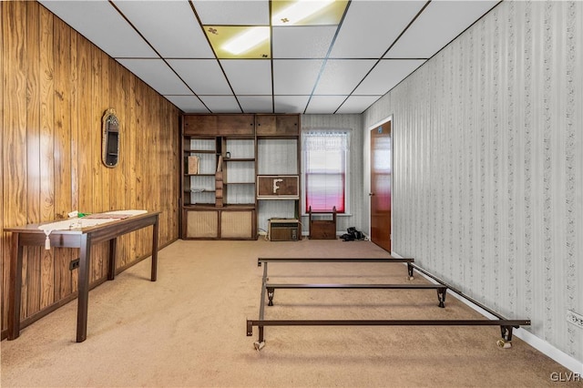 interior space featuring a drop ceiling and light carpet