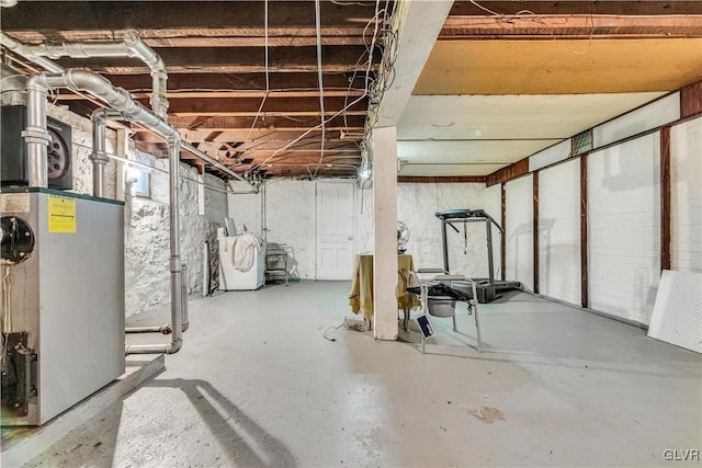 basement featuring washer / clothes dryer and water heater