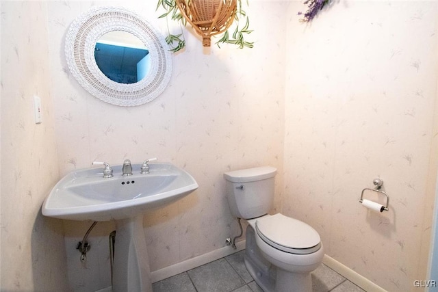 bathroom featuring tile patterned flooring and toilet