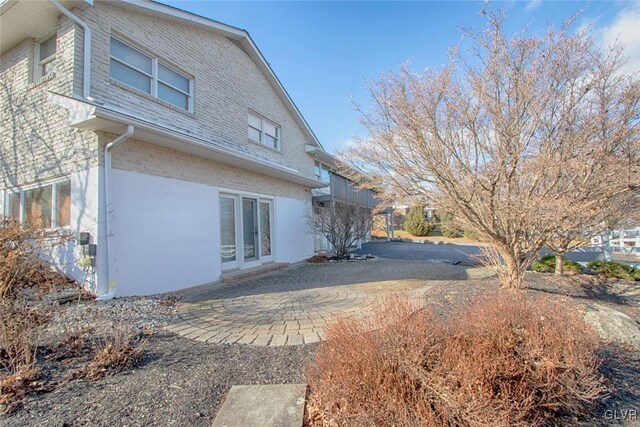 view of side of home with a patio