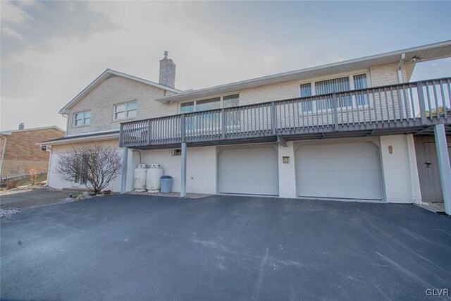 back of property featuring a garage