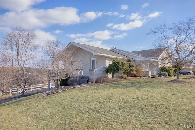 view of side of home featuring a lawn