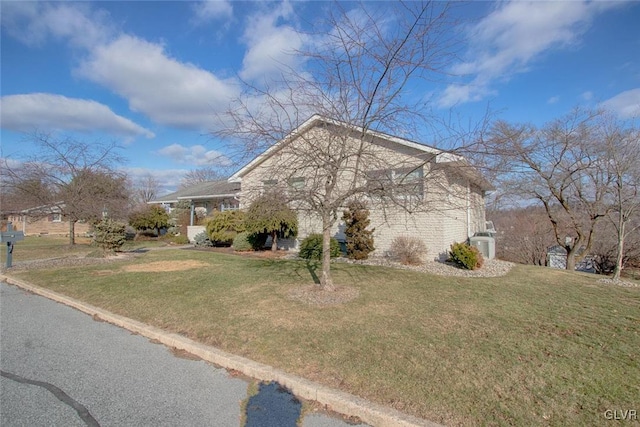 view of side of home featuring a yard