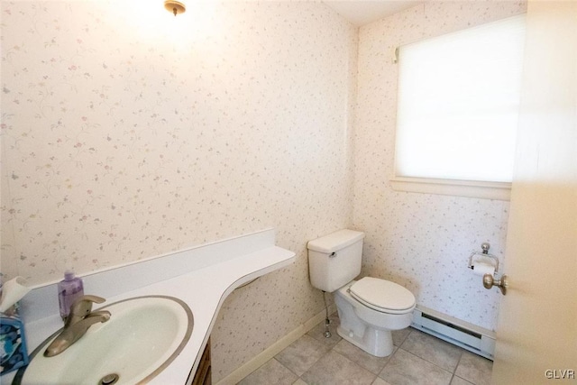 bathroom with tile patterned floors, vanity, toilet, and baseboard heating