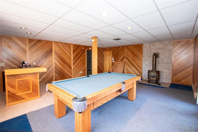 game room featuring a wood stove, wooden walls, and billiards