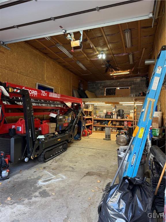 garage with a workshop area and a garage door opener