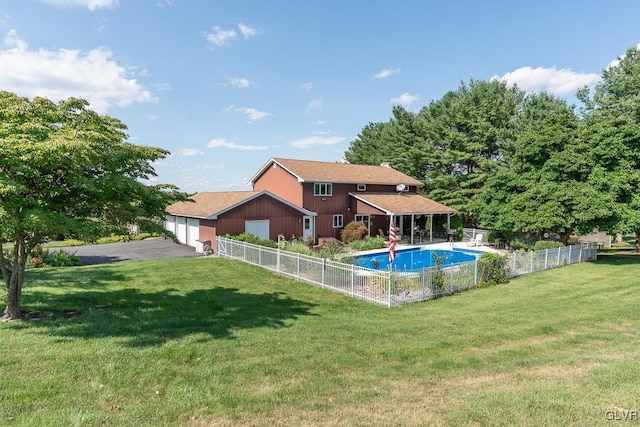 view of pool with a lawn