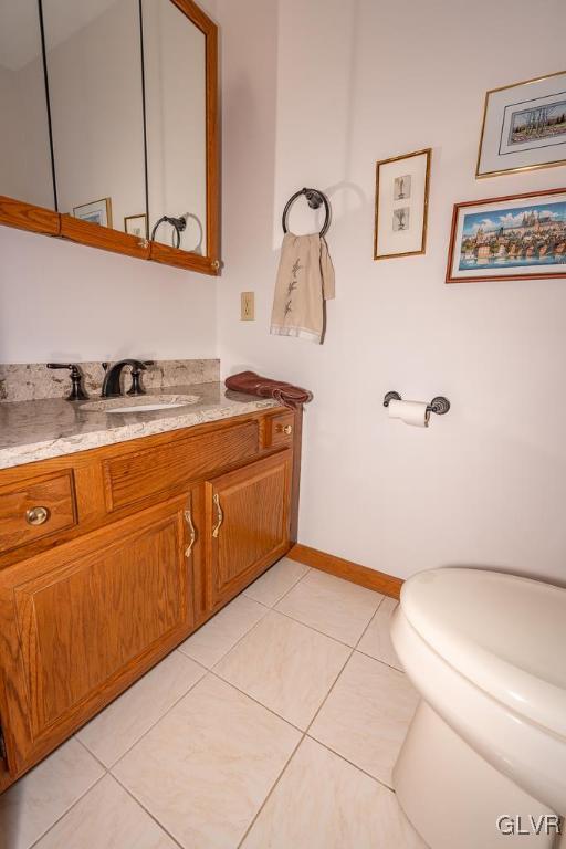 bathroom with tile patterned floors, vanity, and toilet