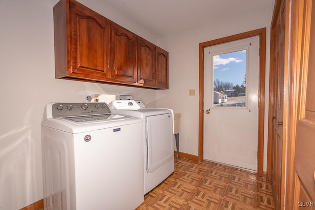 laundry room with cabinets, independent washer and dryer, and light parquet floors