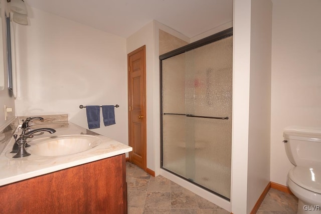 bathroom with vanity, an enclosed shower, and toilet