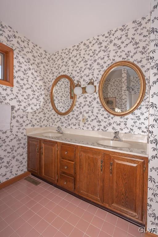 bathroom featuring tile patterned flooring and vanity