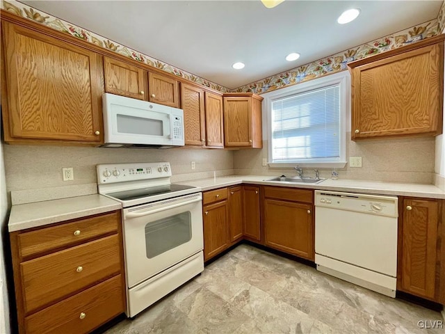 kitchen featuring white appliances and sink