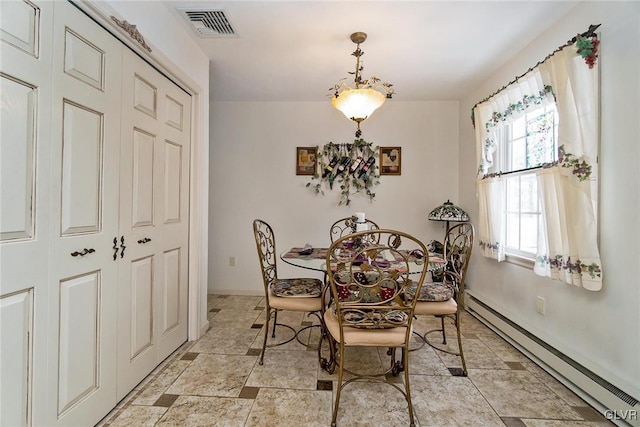 dining space with a baseboard radiator