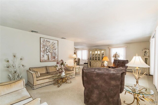 living room featuring baseboard heating and light colored carpet