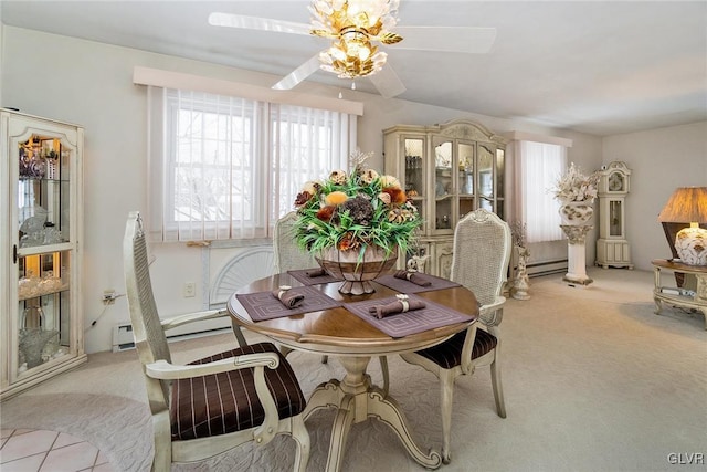 dining room with ceiling fan, light colored carpet, and a baseboard radiator