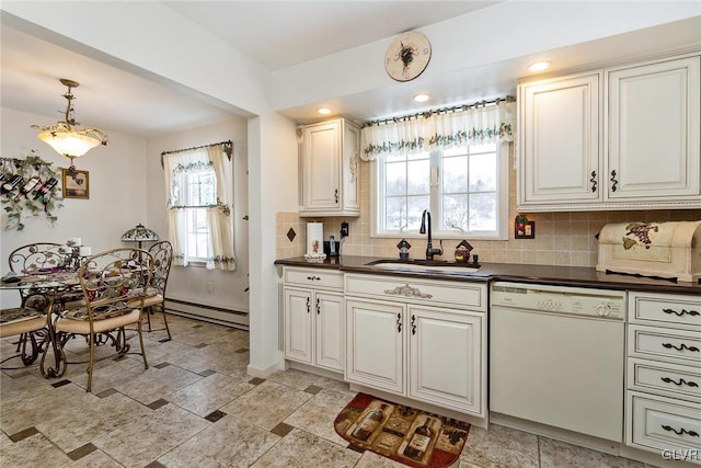 kitchen featuring decorative light fixtures, tasteful backsplash, sink, white dishwasher, and baseboard heating