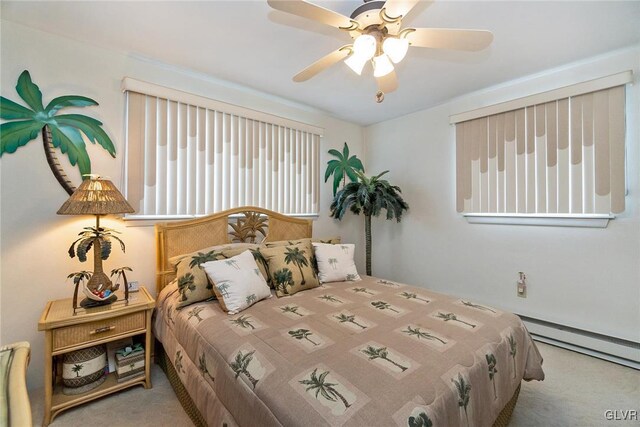 carpeted bedroom with a baseboard radiator and ceiling fan