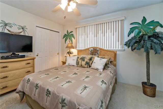 bedroom with ceiling fan, a closet, and light colored carpet