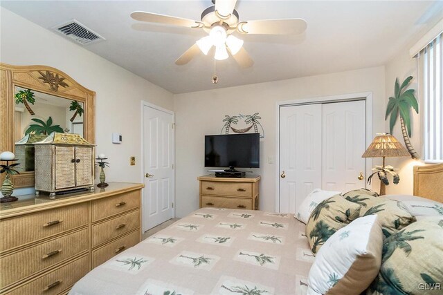 bedroom with ceiling fan and a closet