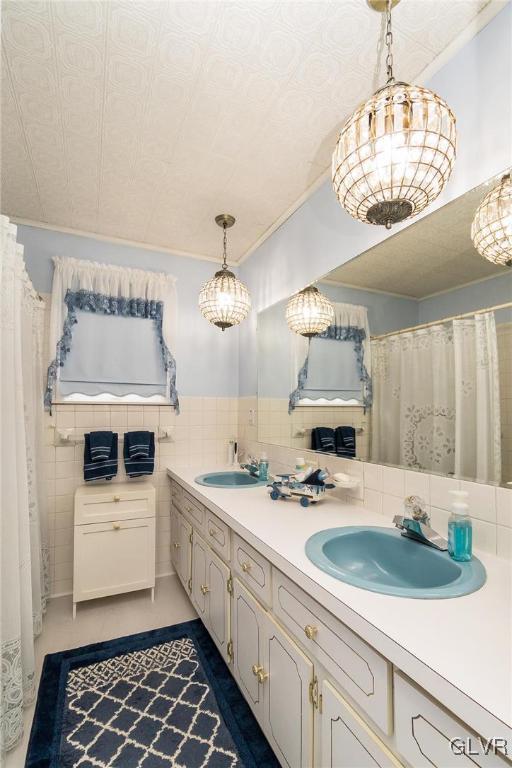 bathroom with tile patterned floors, vanity, and tile walls