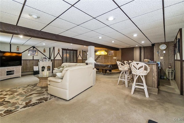 living room featuring wooden walls, carpet floors, a baseboard heating unit, and billiards