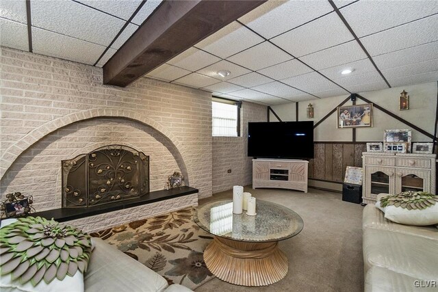 living room featuring a paneled ceiling, a fireplace, carpet, and a baseboard heating unit