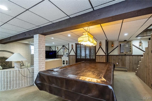 rec room with carpet, a baseboard radiator, wood walls, and pool table