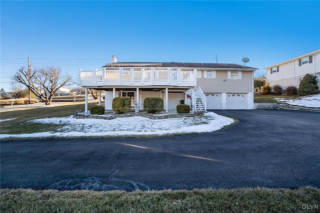 view of front facade with a garage and a deck