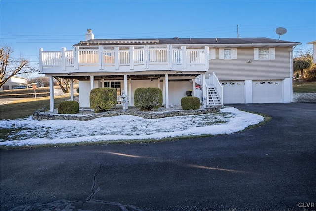 view of front of home featuring a garage and a deck