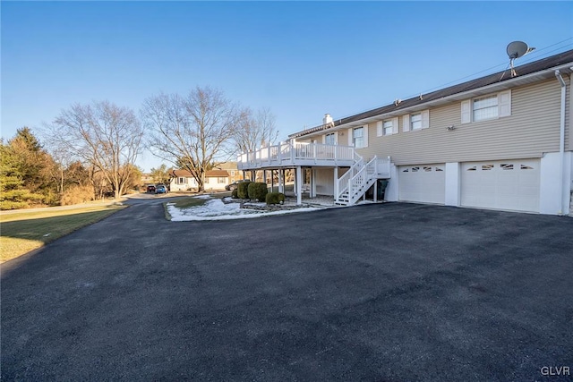 view of front of home with a garage and a wooden deck