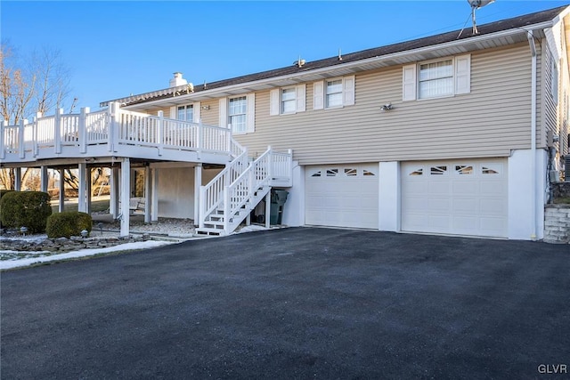 view of front of house with a garage and a deck