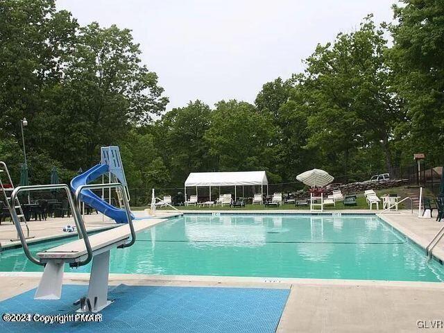 view of pool featuring a water slide