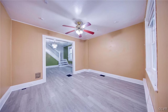 unfurnished room with ceiling fan and light wood-type flooring